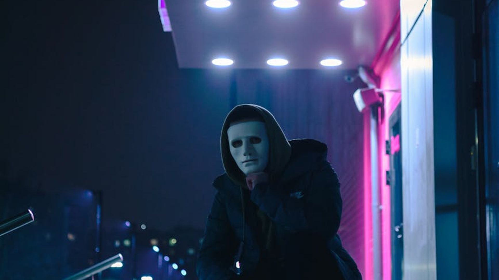 Atmospheric dark yoga studio with neon pink accent lighting